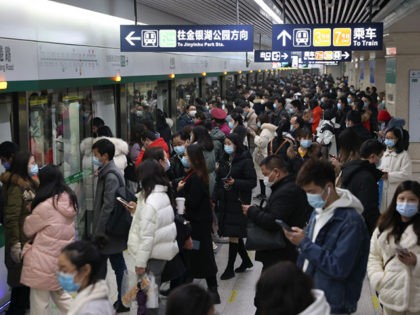 WUHAN, CHINA - JANUARY 28: Chinese commuters wear protective masks as they exit a train at