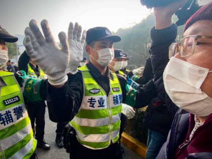 Police attempt to stop journalists from recording footage outside the Shanghai Pudong New District People's Court, where Chinese citizen journalist Zhang Zhan - who reported on Wuhan's Covid-19 outbreak and placed under detention since May - is set for trial in Shanghai on December 28, 2020. (Photo by Leo RAMIREZ …