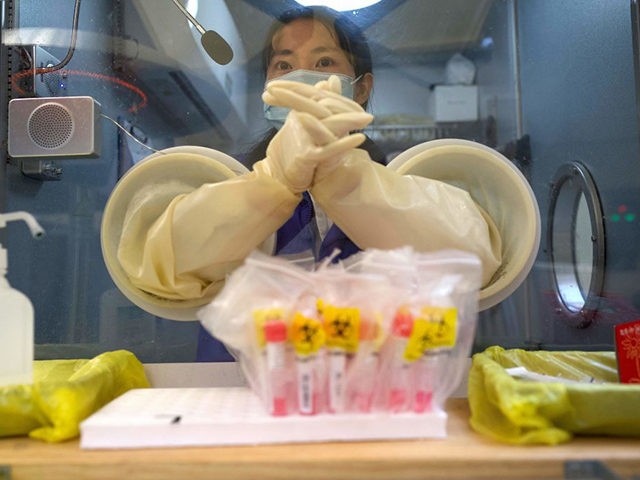 A medical worker waits for the next individual to take a swab test for the COVID-19 corona