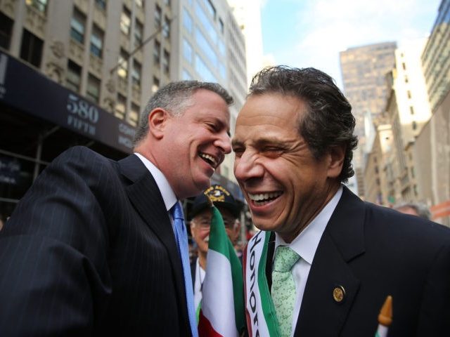 In this file photo, Democratic New York City mayoral candidate Bill de Blasio (L) speaks with New York Governor Andrew Cuomo while marching in the 69th Annual Columbus Day Parade on October 14, 2013 in New York City. (Spencer Platt/Getty Images)