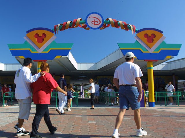 People pass through the ticket/monorail entrance to Walt Disney World November 11, 2001 in