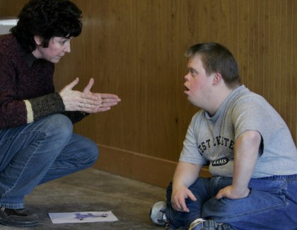 Kim Gockley, left, the program director at Lighthouse Vocational Services talks with Chris Wise using american sign language in New Holland, Pa., Thursday, Feb. 8, 2007, to help him transition to another work activity. At 31, Wise would rather be on his own instead of living with his mother and …