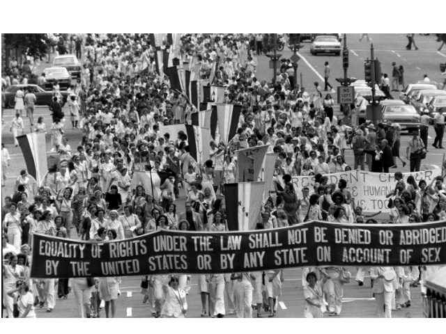 Supporters of the Equal Rights Amendment carry a banner down Pennsylvania Avenue in Washington D.C. on Friday, August 26, 1977. The march followed a ceremony in the White House Rose Garden during which U.S. President Carter signed a Women's Equality Day proclamation. (AP Photo)