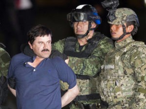 In this Jan. 8, 2016 file photo, Joaquin "El Chapo" Guzman is made to face the press as he is escorted to a helicopter in handcuffs by Mexican soldiers and marines at a federal hangar in Mexico City, Mexico, following his recapture six months after escaping from a maximum security prison. (AP Photo/Eduardo Verdugo, File)