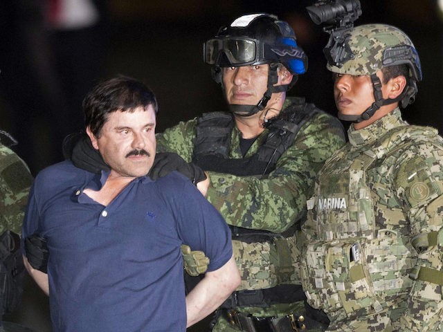 In this Jan. 8, 2016 file photo, Joaquin "El Chapo" Guzman is made to face the press as he is escorted to a helicopter in handcuffs by Mexican soldiers and marines at a federal hangar in Mexico City, Mexico, following his recapture six months after escaping from a maximum security …