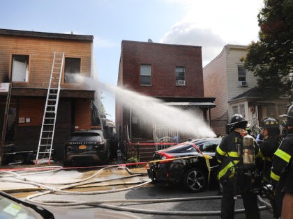 In this file photo, firefighters spray water on a house fire with reports of an explosion on September 30, 2019 in the Kensington neighborhood of the Brooklyn borough of New York City. (Spencer Platt/Getty Images)