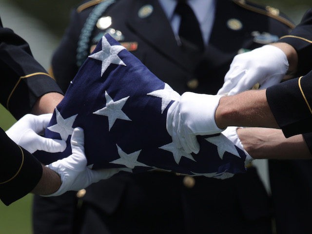 Members of the U.S. Army's 3rd Infantry Regiment "The Old Guard" fold a flag during the fu
