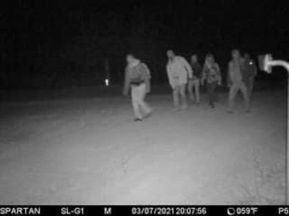 A rancher's game-cam captures a group of migrants marching through his ranch to avoid a Border Patrol checkpoint. (Photo: Kinney County Sheriff's Office)