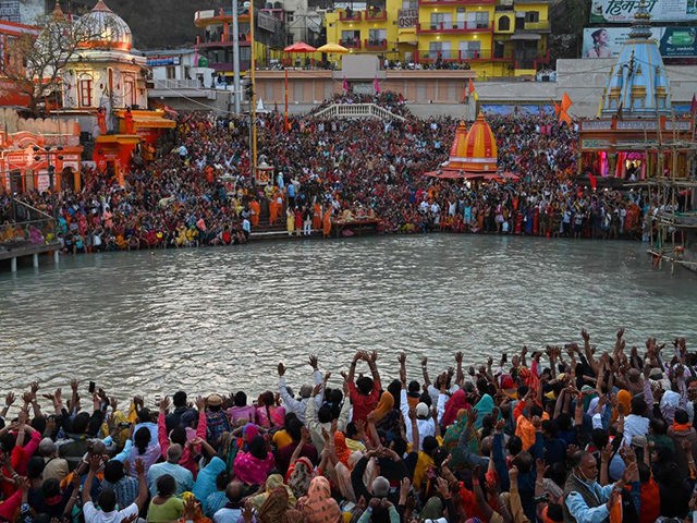 Hindu devotees attend evening prayers after taking a holy dip in the waters of the River Ganges on the Shahi Snan (grand bath) on the occasion of the Maha Shivratri festival during the ongoing religious Kumbh Mela festival in Haridwar on March 11, 2021. (Photo by Prakash SINGH / AFP) …