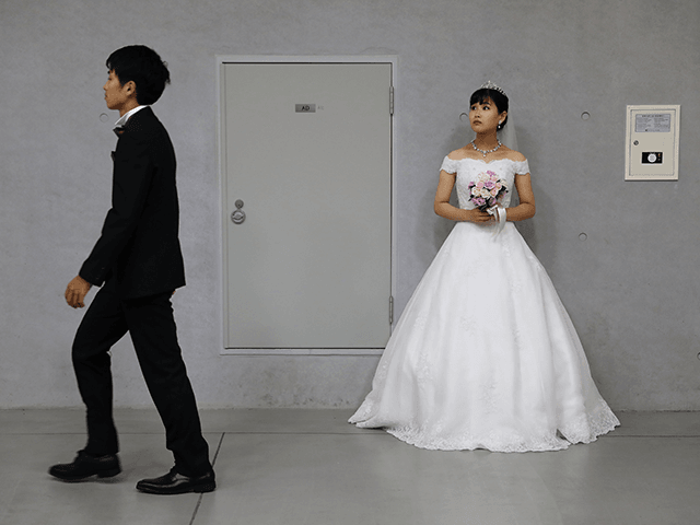 A bride waiting in the queue during an wedding ceremony of the Family Federation for World Peace and Unification, commonly known as the Unification Church, at Cheongshim Peace World Center on August 27, 2018 in Gapyeong-gun, South Korea. Some 4,000 'Moonies', believers of Unification Church, which was named after the …
