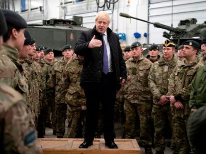 Britain's Prime Minister Boris Johnson speaks with the Queen's Royal Hussars (the senior United Kingdom armoured regiment) stationed in Estonia at the Tapa military base on December 21, 2019, during a one-day visit to the Baltic country. - Tapa military base is home to 850 British troops from the Queen's …
