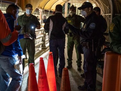 US Customs and Border Protection and Border Patrol agents wearing masks for protection against COVID-19 check pedestrians IDs on April 1, 2020, on the Paso del Norte International Bridge between Ciudad Juarez, Mexico and El Paso, Texas. - Both Ciudad Juarez and El Paso, Texas, are on stay-at-home orders, but …