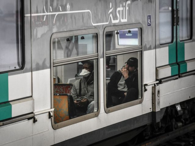 A commuter wearing a protective facemask sits in the carriage of a RER suburban train in Paris on April 9, 2020, on the twenty-fourth day of a lockdown in France to attempt to halt the spread of the novel coronavirus COVID-19. (Photo by STEPHANE DE SAKUTIN / AFP) (Photo by …