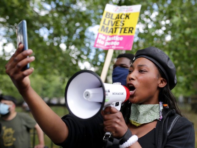 LONDON, ENGLAND - JUNE 13: An anti-racism protester speaks through a megaphone during a Black Lives Matter protest on June 13, 2020 in London, England. A number of anti-racism protesters have gathered in London despite the cancellation of the official event due to fears of clashes with far-right groups. Following …