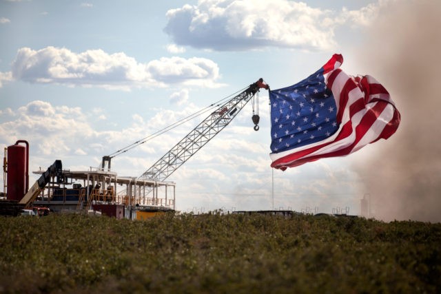 MIDLAND, TX - JULY 28: The American flag is raised at the site of a Double Eagle Energy rig on July 28, 2020 in Midland, Texas. President Donald Trump is making his 16th visit to the state, where he will tour a rig owned by Double Eagle Energy and deliver …