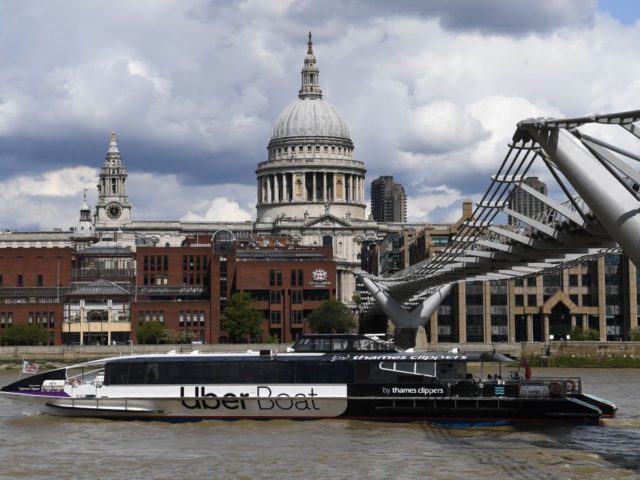 An Uber boat passes St Paul's cathedral in partnership with Thames clippers the boat