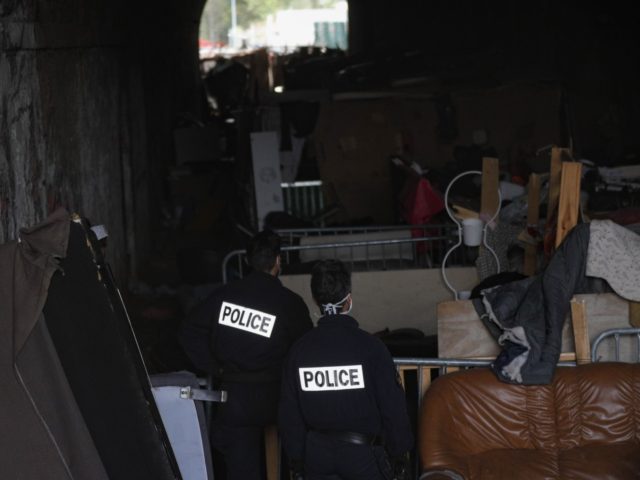 Police officers look inside a tunnel used by crack addicts during an evacuation operation in the 19th arrondissement of Paris on September 3, 2020. - 86 persons, including crack addicts, prostitues, migrants and unaccompanied minors, have been evacuated from a tunnel near a RER station in the northern 19th arrondissement …