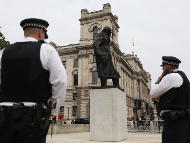 Police officers stand near the statue of Britain's former prime minister Winston Churchill in Parliament Square in London on September 11, 2020. The statue has been cleaned after being vandalised with graffiti. (Photo by ISABEL INFANTES / AFP) (Photo by ISABEL INFANTES/AFP via Getty Images)