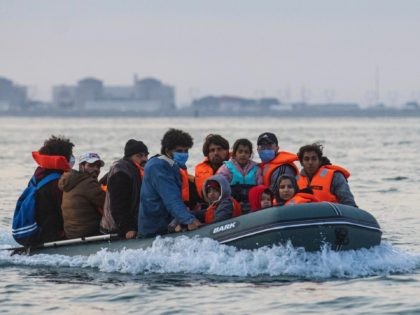 Waleed (C), 29, a Kuwaiti migrant, sits in a dinghy with his brother's family and other migrants as they illegally cross the English Channel from France to Britain on September 11, 2020. - The number of migrants crossing the English Channel -- which is 33,8 km (21 miles) at the …