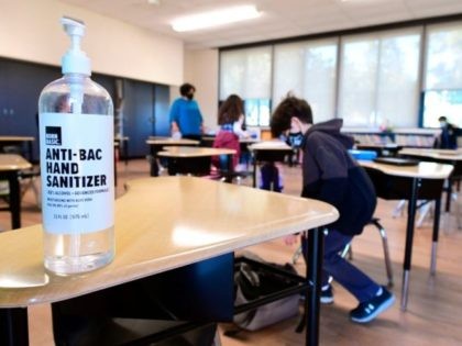 A large container of hand sanitizer sits on a desk for students to use in Second Grade instructor Marisela Sahagun's classroom at St. Joseph Catholic School in La Puente, California on November 16, 2020, where pre-kindergarten to Second Grade students in need of special services returned to the classroom today …