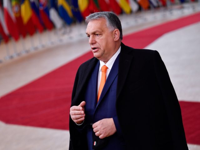 Hungary's Prime Minister Viktor Orban speaks to the press as he arrives at the EU hea