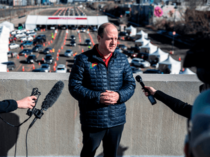 Colorado Governor Jared Polis speaks to the press as he visits the site of a mass vaccination drive through at Coors Field baseball stadium on January 30, 2021, in Denver, Colorado. - UCHealth, the organizer and Colorado's largest healthcare provider, has set the goal of vaccinating 10,000 people over the …