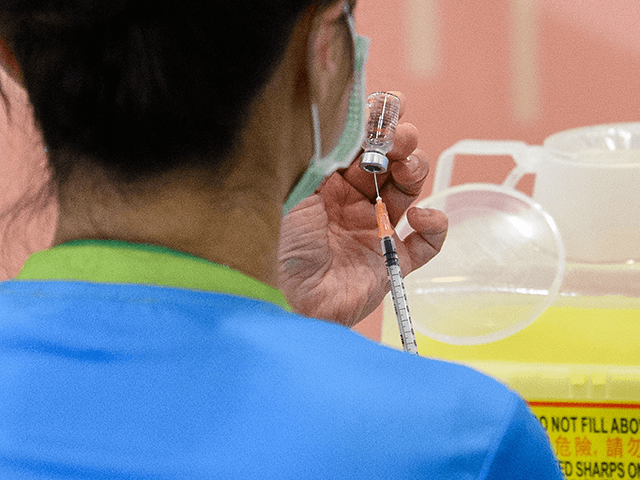 A medic holds a vial of China's Sinovac COVID-19 coronavirus vaccine as she prepares to gi