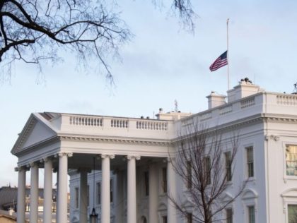 The American flag is seen at half staff over the White House in Washington, DC, February 2