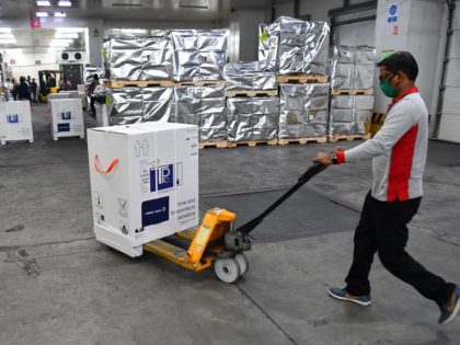 Airport staff unloads carton boxes of Covishield vaccine developed by Pune based Serum Institute of India (SII) at the Mumbai airport on February 24, 2021, as part of the Covax scheme, which aims to procure and distribute inoculations fairly among all nations. (Photo by INDRANIL MUKHERJEE / AFP) (Photo by …