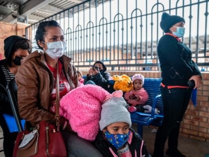 Migrant families wait for their bus at a bus station in Brownsville, Texas before travelling to meet relatives or sponsors on March 2, 2021. - President Biden announced that he was ending the Migrant Protection Protocol (MPP) enacted under President Trump that sent asylum seekers back to Mexico as they …