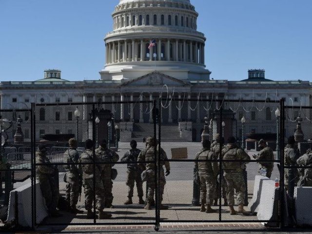 Members of the National Guard watch a checkpoint on Capitol Hill on March 5, 2021, in Washington, DC. - Armed US National Guard troops patrolled the US Capitol on March 4 after officials warned of a new attack plot by extremists, but the feared show of force by those still …