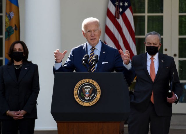 US President Joe Biden, with Vice President Kamala Harris (L) and Senate Majority Leader Chuck Schumer, Democrat of New York, speaks about the American Rescue Plan in the Rose Garden of the White House in Washington, DC, on March 12, 2021. (Photo by Olivier DOULIERY / AFP) (Photo by OLIVIER …
