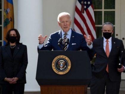 US President Joe Biden, with Vice President Kamala Harris (L) and Senate Majority Leader Chuck Schumer, Democrat of New York, speaks about the American Rescue Plan in the Rose Garden of the White House in Washington, DC, on March 12, 2021. (Photo by Olivier DOULIERY / AFP) (Photo by OLIVIER …