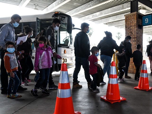 Migrants mostly from Central America are dropped off by the US Customs and Border Protection at a bus station near the Gateway International Bridge, between the cities of Brownsville, Texas, and Matamoros, Mexico, on March 15, 2021, in Brownsville, Texas. - It's the new normal for migrant families under President …