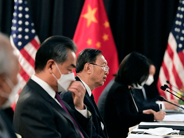The Chinese delegation led by Yang Jiechi (C), director of the Central Foreign Affairs Commission Office and Wang Yi (2nd L), China's Foreign Minister, speak with their US counterparts at the opening session of US-China talks at the Captain Cook Hotel in Anchorage, Alaska on March 18, 2021. - China's …