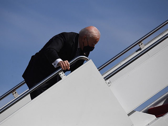 US President Joe Biden trips as he boards Air Force One at Joint Base Andrews in Maryland on March 19, 2021. - President Biden travels to Atlanta, Georgia, to tour the Centers for Disease Control and Prevention, and to meet with Georgia Asian American leaders, following the Atlanta Spa shootings. …