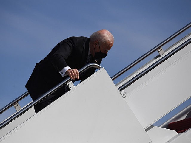 US President Joe Biden trips as he boards Air Force One at Joint Base Andrews in Maryland