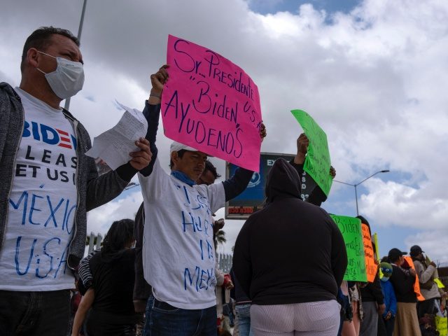Migrants and asylum seekers demonstrate at the San Ysidro crossing port asking US authorities to allow them to start their migration process in Tijuana, Baja California state, Mexico on March 23, 2021. - Migrants out of MPP program are stranded along the US-Mexico border without knowing when or how they …