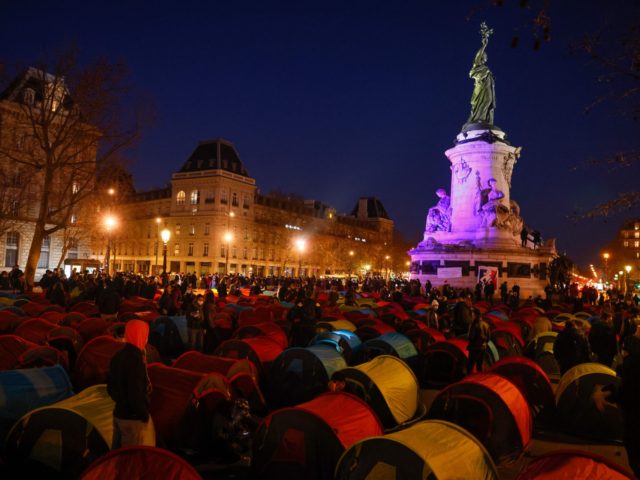 TOPSHOT - People settle in one of 300 tents set-up in La Place de la Republique for the start of a night of Solidarity organised by Collectif Requisitions to highlight the plight of the homeless in central Paris on March 25, 2021. (Photo by Thomas SAMSON / AFP) (Photo by …