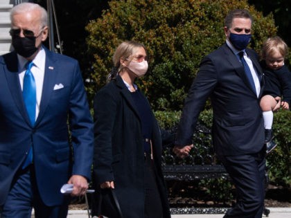 US President Joe Biden walks to speak to the media as his son, Hunter Biden (R) and wife Melissa Cohen (C) and their child Beau, walk behind prior to departing on Marine One from the South Lawn of the White House in Washington, DC, March 26, 2021, as he travels …