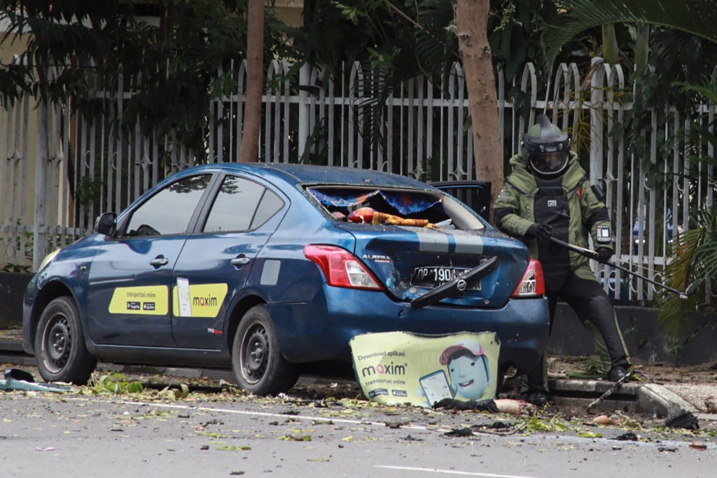 An Indonesian anti-bomb unit (C) collects evidence after a bomb exploded in Makassar on March 28, 2021. ( IRVAN ABDULLAH/AFP via Getty)