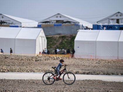 A child rides a bicycle inside the new refugee camp of Kara Tepe in Mytilene, on Lesbos, on March 29, 2021. - EU home affairs commissioner Ylva Johansson pledged 276 million euros ($326 million) of EU money for new camps on the islands of Lesbos, Chios, Samos, Kos and Leros, …