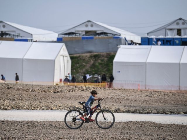 A child rides a bicycle inside the new refugee camp of Kara Tepe in Mytilene, on Lesbos, o