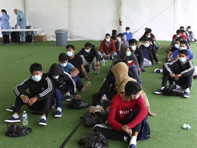 Young migrants wait to be tested for Covid-19 at the Department of Homeland Security holding facility on March 30, 2021 in Donna, Texas. The Donna location is the main detention center for unaccompanied children coming across the U.S. border in the Rio Grande Valley. (Photo by Dario Lopez-Mills - Pool/Getty Images)