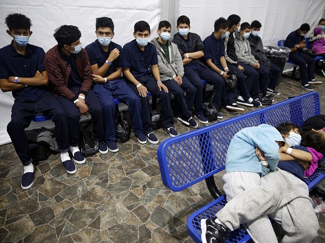 DONNA, TEXAS - MARCH 30: Young unaccompanied migrants, wait for their turn at the secondary processing station in the Department of Homeland Security holding facility on March 30, 2021 in Donna, Texas. The Donna location is the main detention center for unaccompanied children coming across the U.S. border in the Rio Grande Valley. The youngest of the unaccompanied minors are kept separate from the rest of the detainees. The Biden administration has just allowed journalists inside its main detention facility at the border for migrant children. It is an overcrowded tent structure where more than 4,000 kids and families are kept in pods, with the youngest kept in a large play pen with mats on the floor for sleeping. (Photo by Dario Lopez-Mills - Pool/Getty Images)