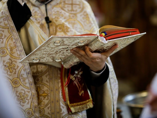 Bucharest, Romania - May 24, 2020: Details of an Orthodox priest reading from the Holy Bib