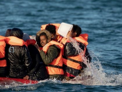 AT SEA, UNITED KINGDOM - SEPTEMBER 07: Migrants packed tightly onto a small inflatable boa