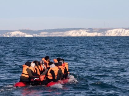 AT SEA, UNITED KINGDOM - SEPTEMBER 07: Migrants packed tightly onto a small inflatable boa