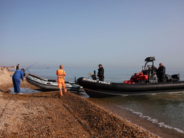 DEAL, ENGLAND - SEPTEMBER 14: Border Force Officials recover a dinghy after migrants landed on Deal beach after crossing the English channel from France on September 14, 2020 in Deal, England. More than 1,468 migrants, some of them children, crossed the English Channel by small boat in August, despite a …
