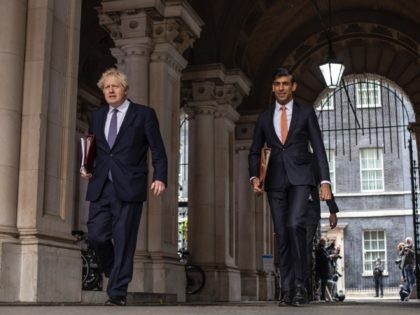 LONDON, ENGLAND - OCTOBER 13: British Prime Minister Boris Johnson and Chancellor Rishi Sunak head to the weekly cabinet meeting at the British Foreign and Commonwealth Office on October 13, 2020 in London, England. The Prime Minister chairs first full meeting of the government's decision making unit after announcing their …